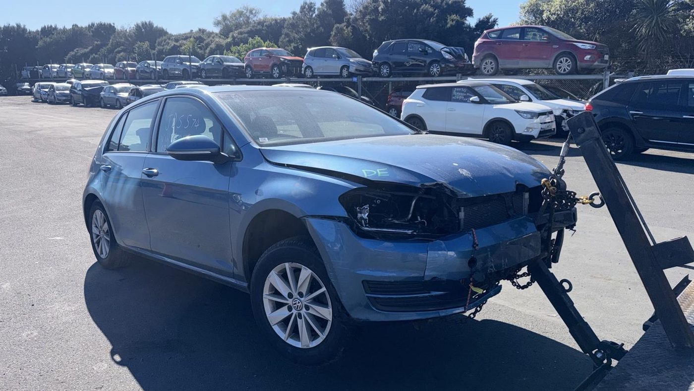 Accident-damaged blue VW Golf with front-end damage in the Ashburton wreckers' yard
