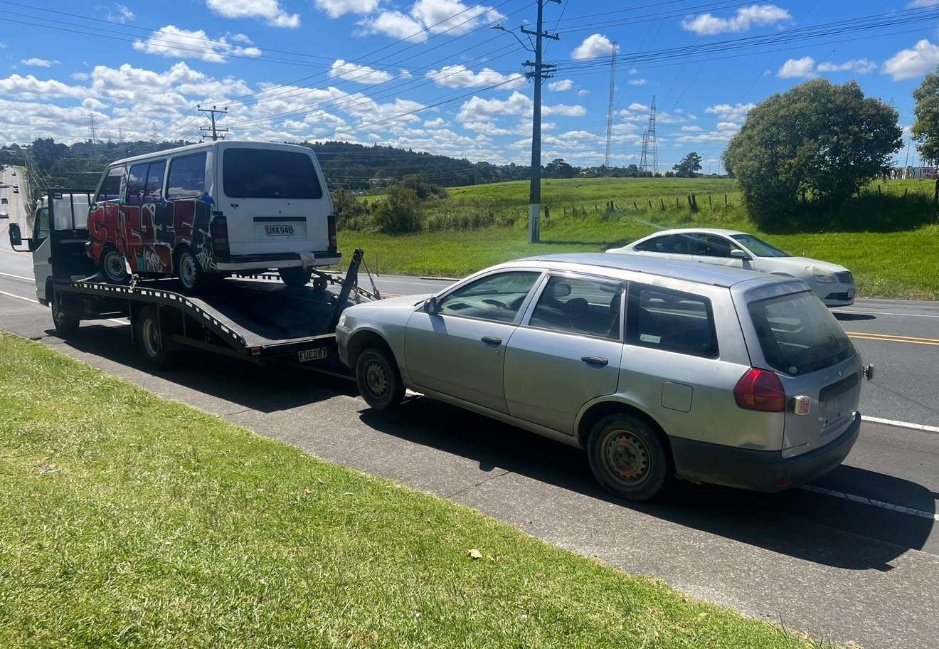 Cash For Cars Ashburton tow truck loaded with a van and towing a wagon on a Mid Canterbury roadside
